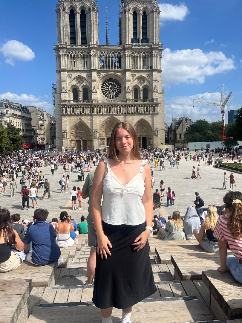 Riley standing in front of Notre Dame in Paris