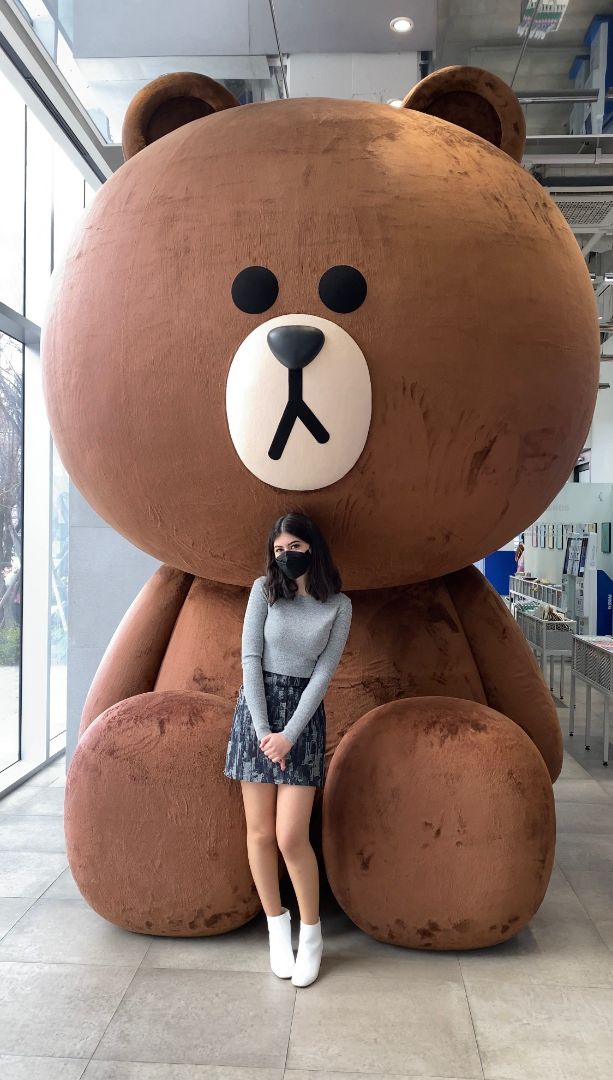 Daoud standing in front of giant teddy bear