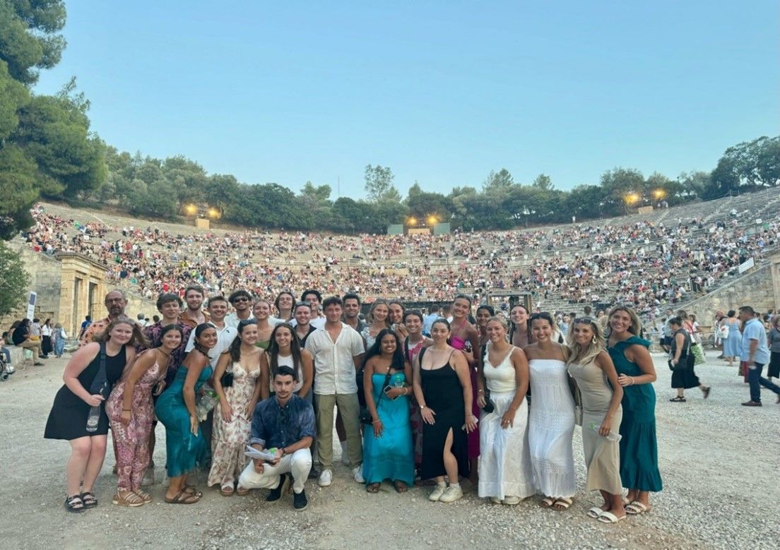 Group of students posing in an ancient greek amphatheatre in Greece