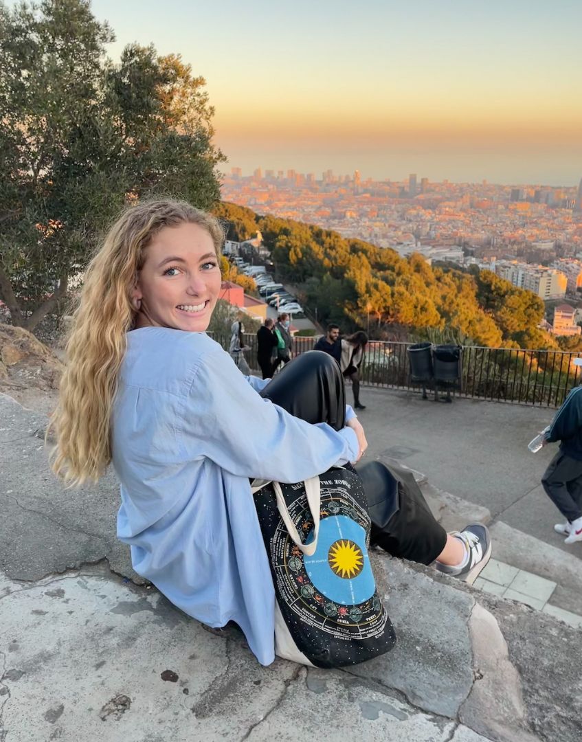 Elise sitting on stone steps in Spain