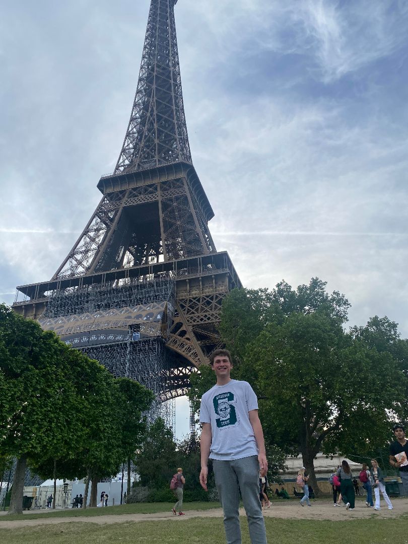 Jake standing in front of Eiffel Tower in Paris, France