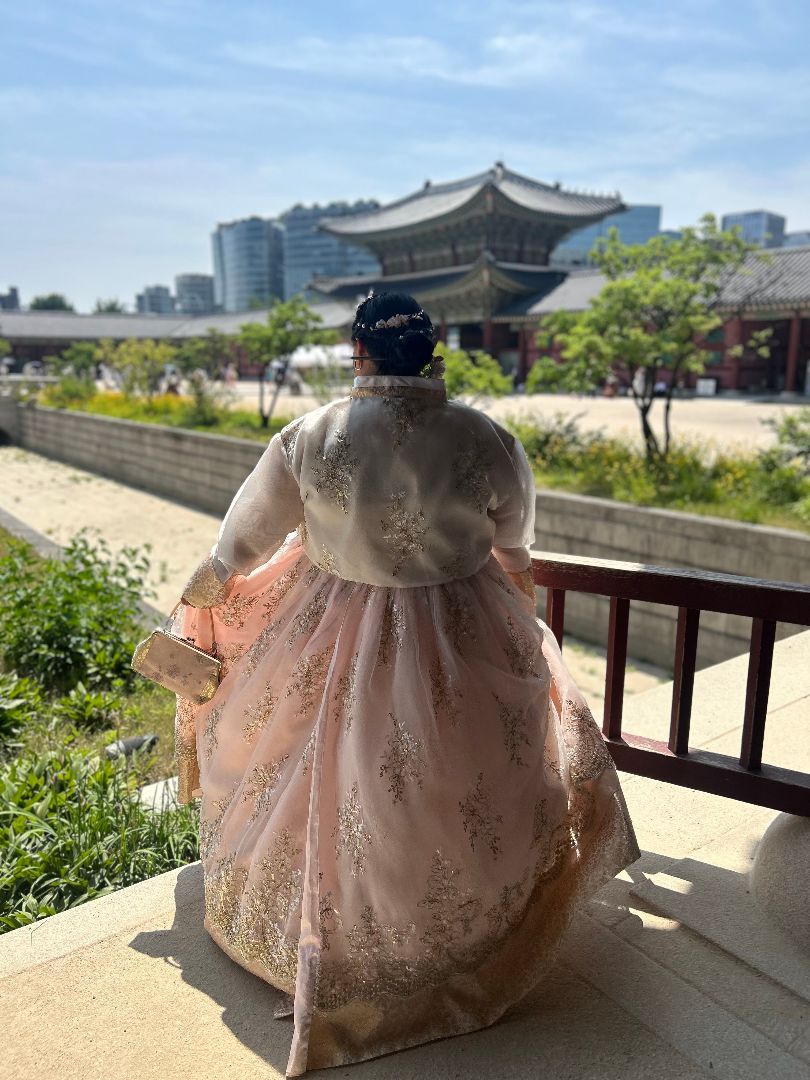 Mina wearing a beautiful light pink traditional Korean dress