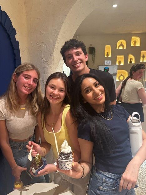 Aidan and friends pose for a photo holding gelato in a local cafe