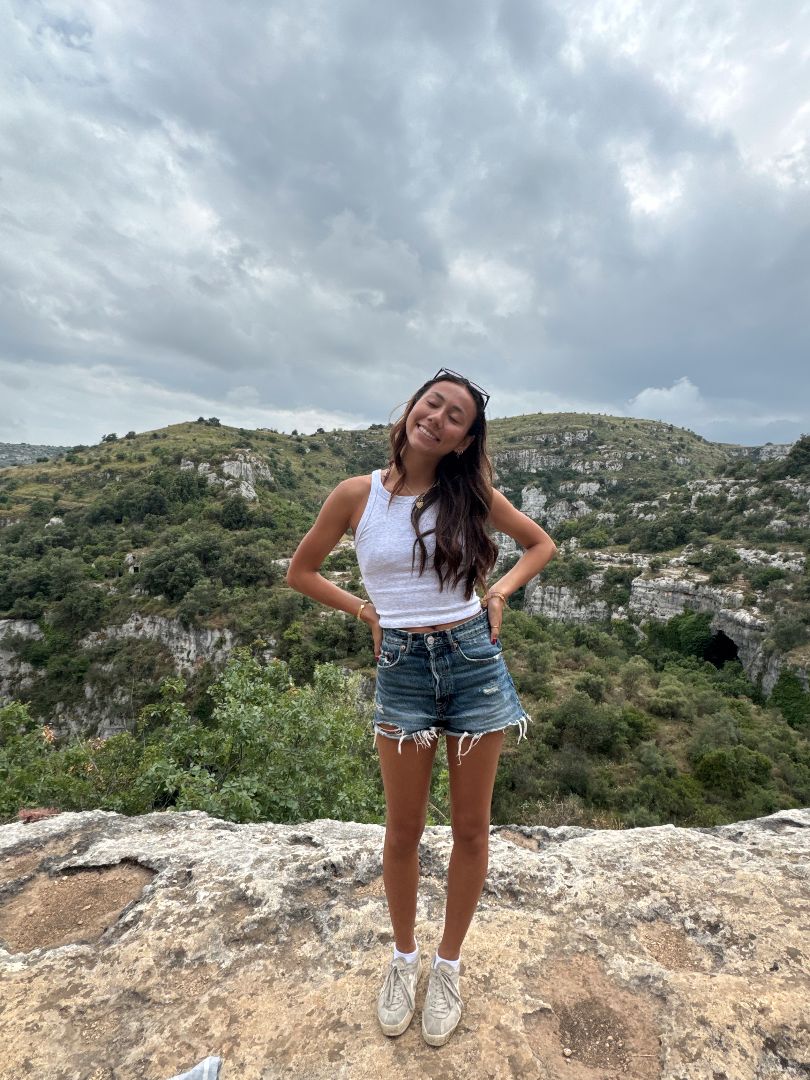 Jade standing on a stone mountain in Spain