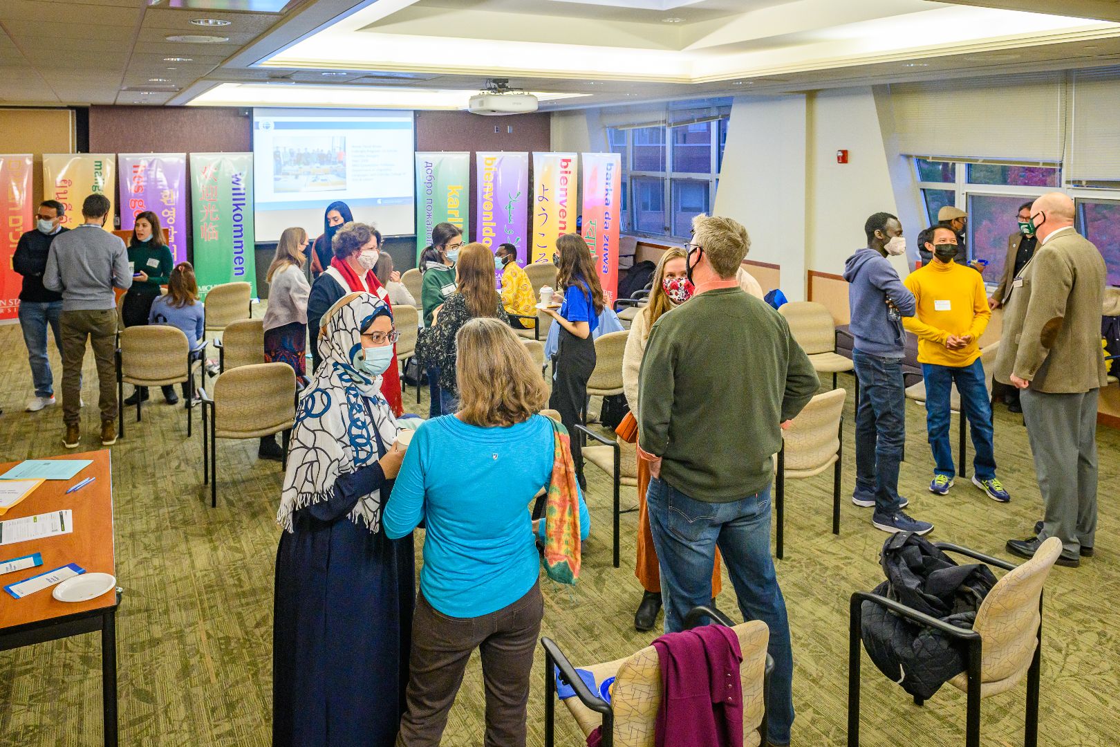 Open house participants connect with each other in the event space.