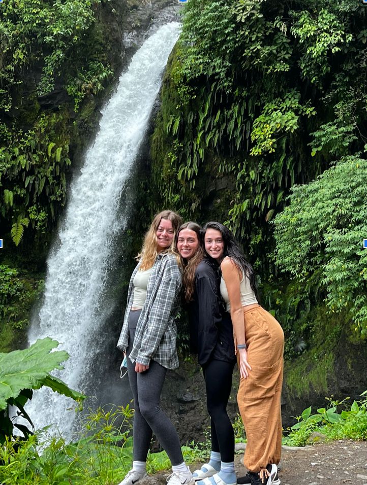 Alyssa and two other students standing in front of a waterfall in Costa Rica