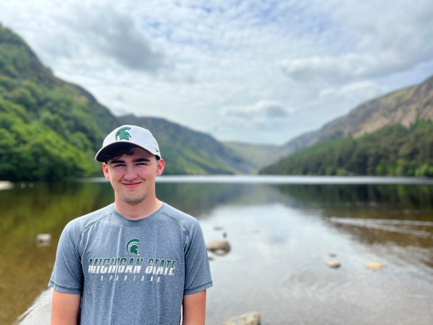 Andrew in front of lake while hiking in Glendalough, Ireland