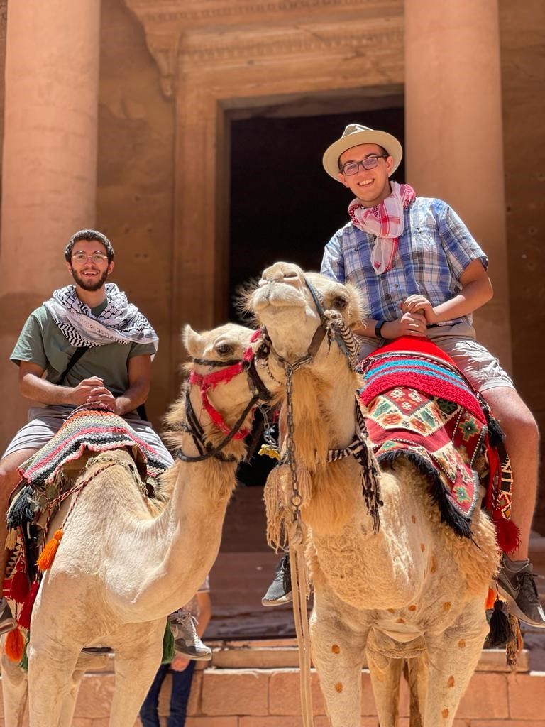 Wesley riding a camel in Jordan
