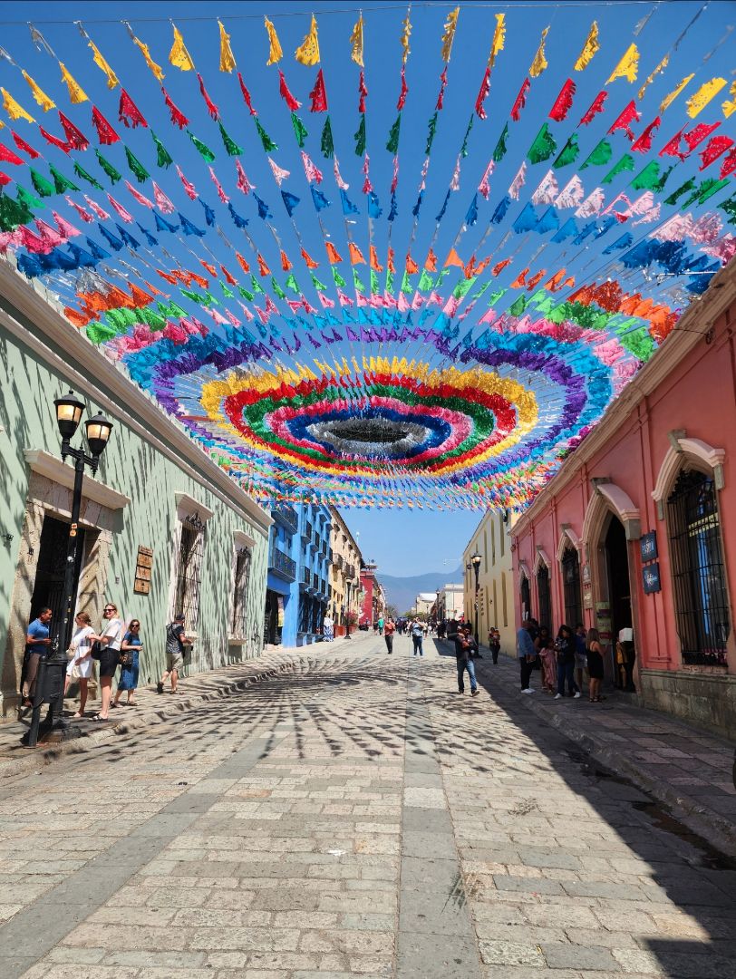 Colorful flags hanging above a local street in Mexico