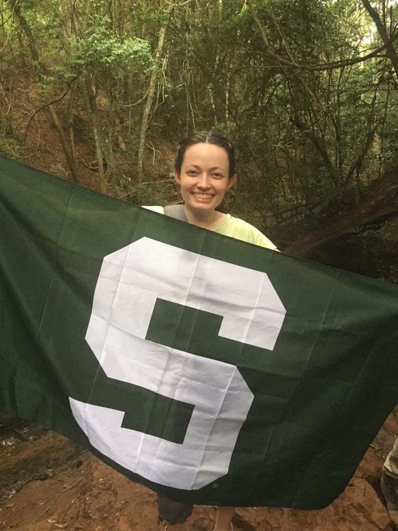 Rachel holding Spartan flag in Kenya