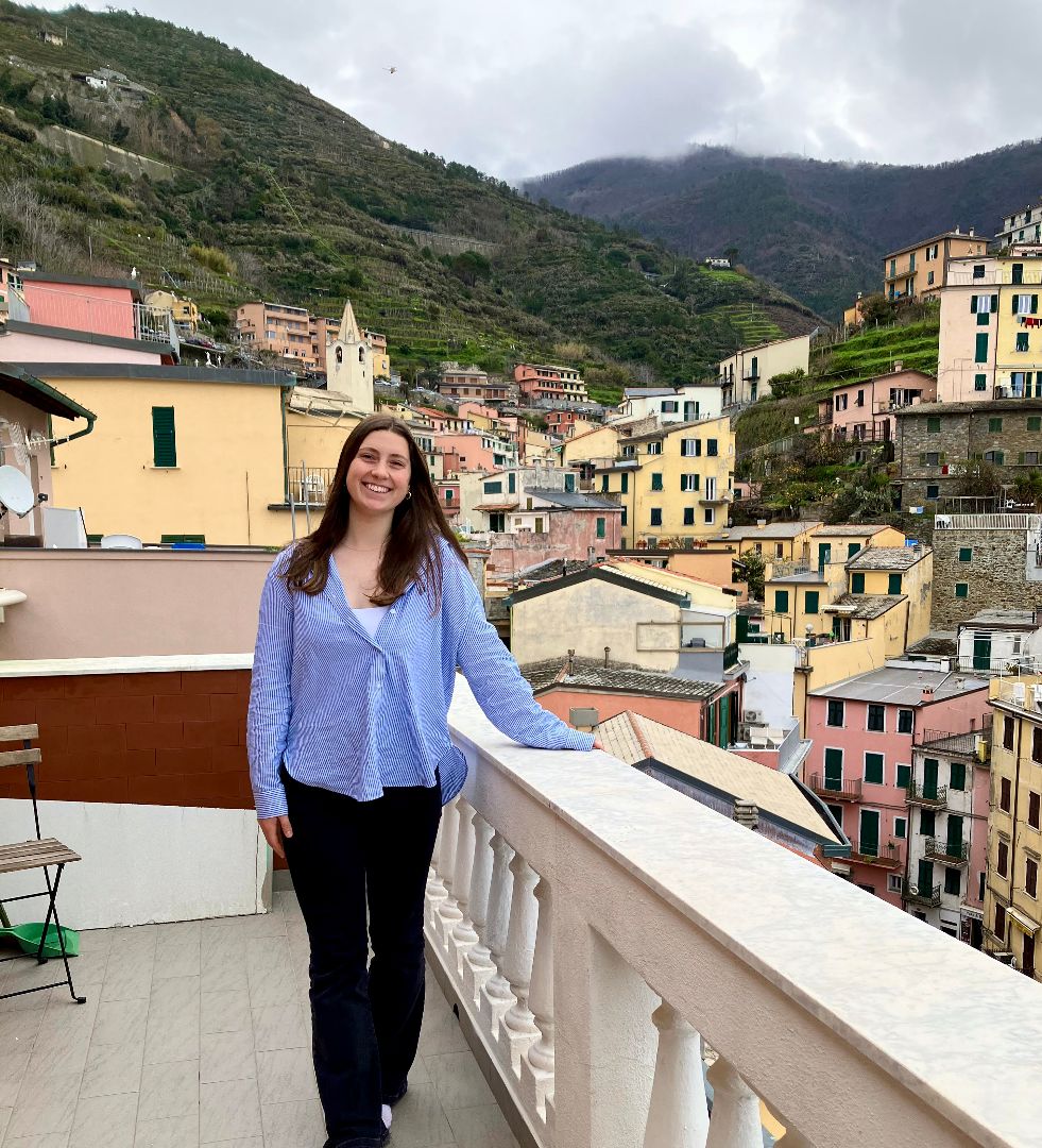 Amy standing on a balcony in Cinque Terre, Italy