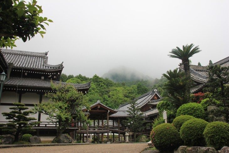 a temple and greenery in a cloudy day