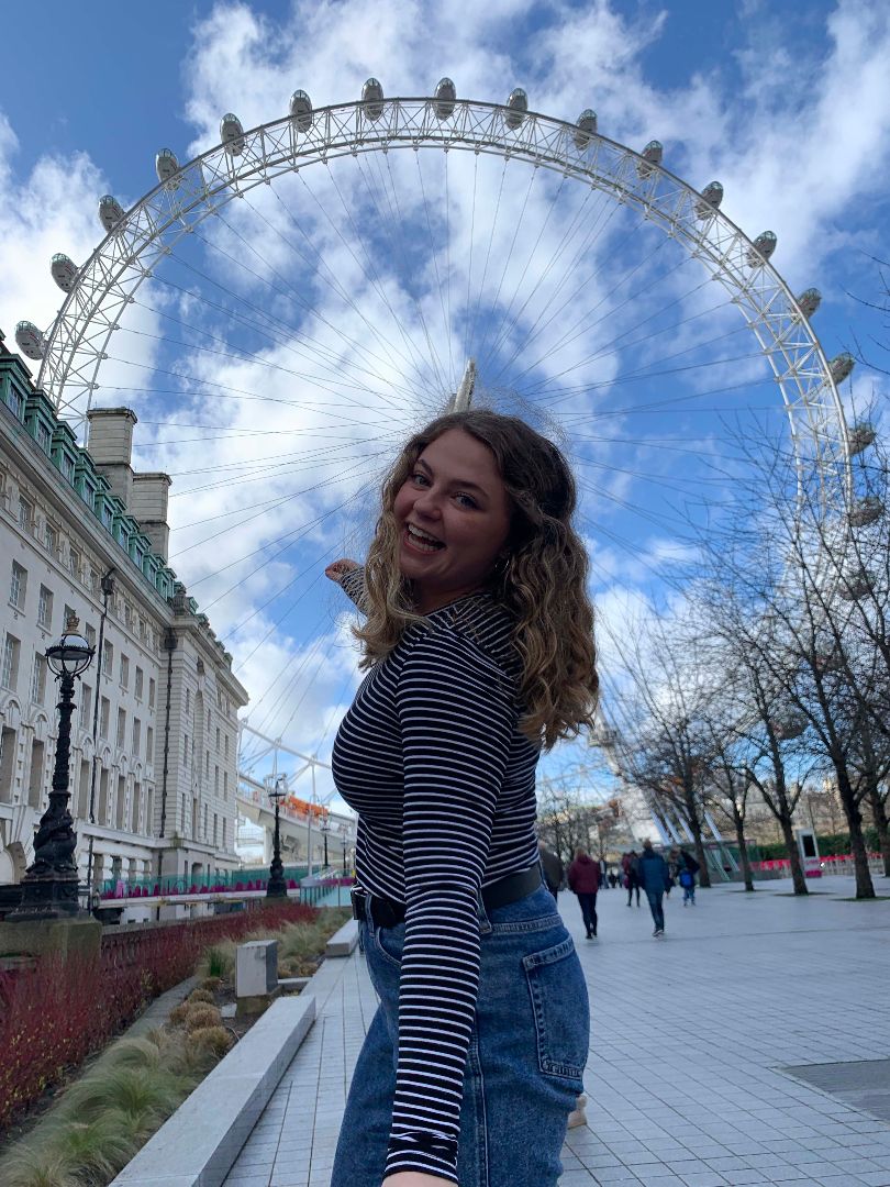 Maddie in front of the London Eye in England