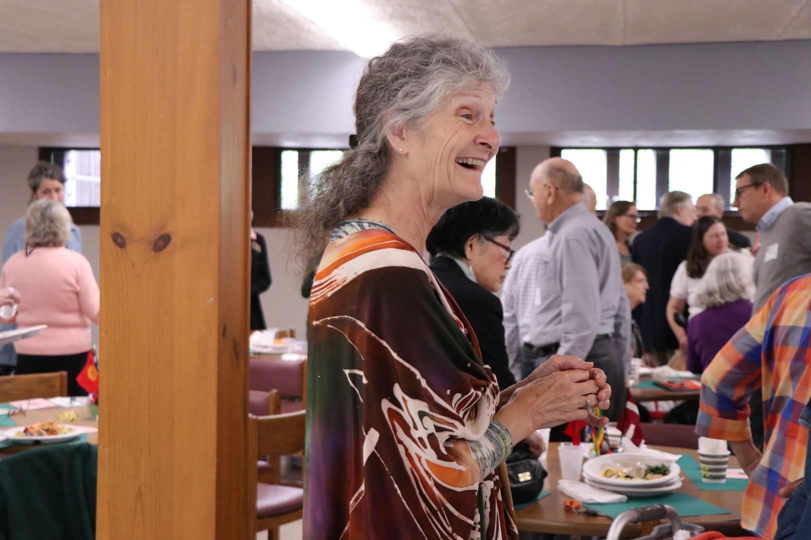 Marge Weldon CVIP, board member at CVIP luncheon. She is standing and smiling.