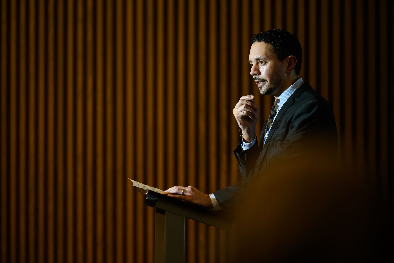 Khalil introduces speakers at the microphone
