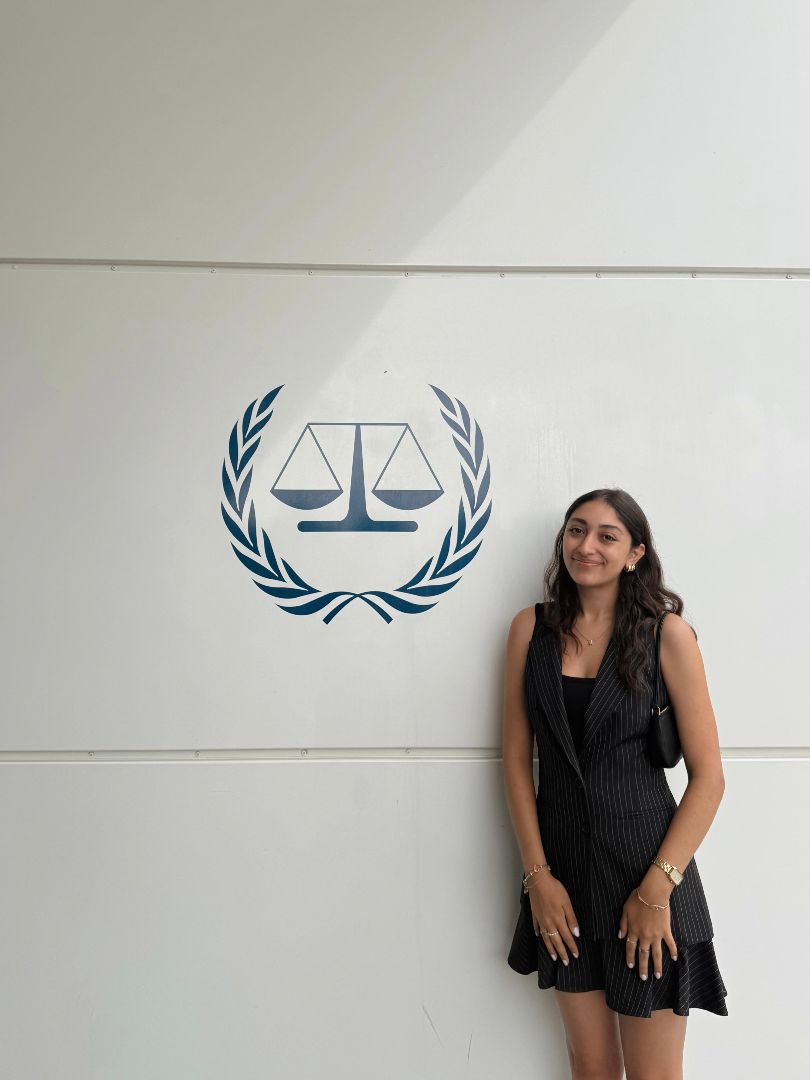 Andrea standing by a United Nations logo