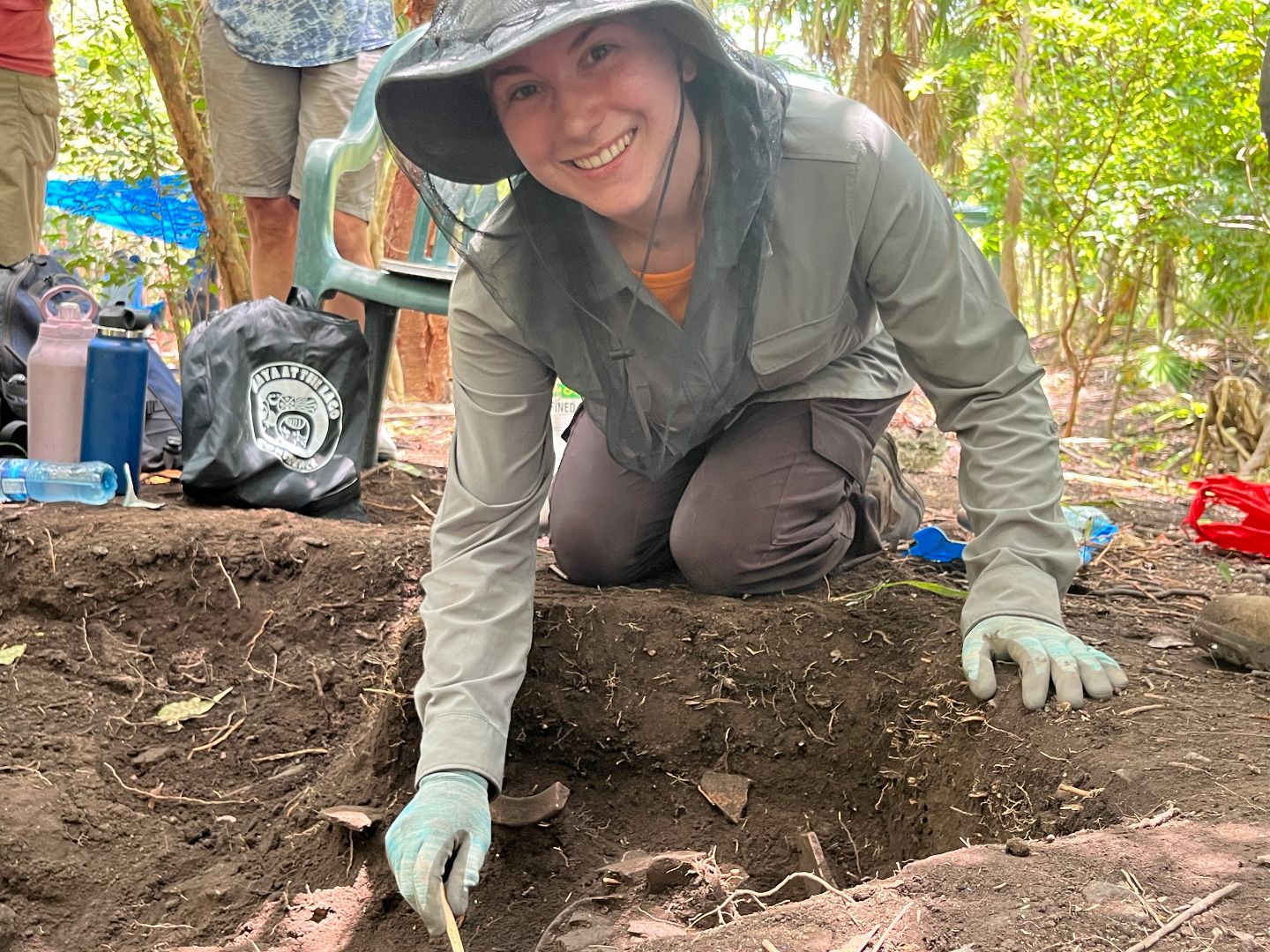 Cordelia digging in the ground during excavation