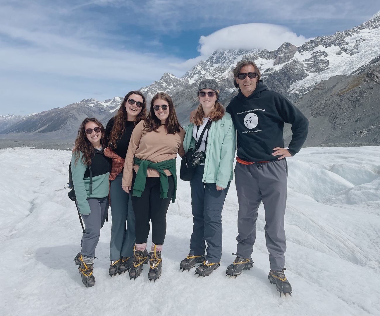 Group of students posing for photo on top of a glacier