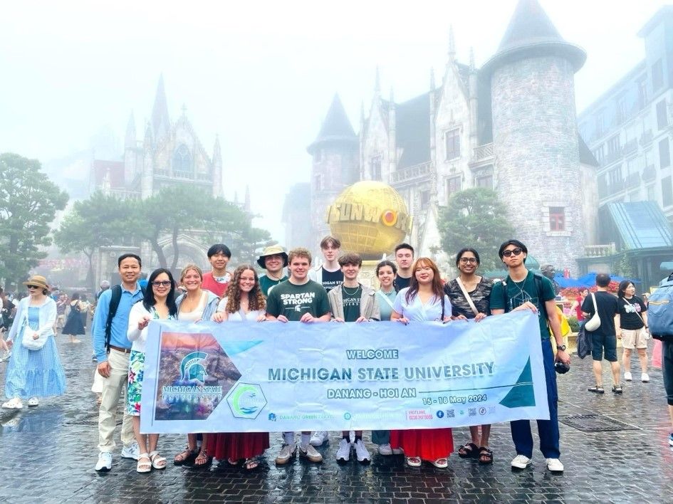 Group of students holding an MSU sign i n Vietnam