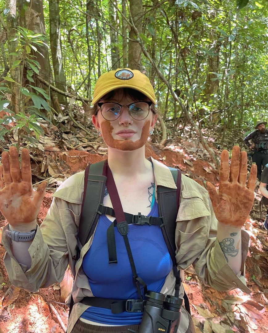 Allison in Costa Rica with mud on her hands and face