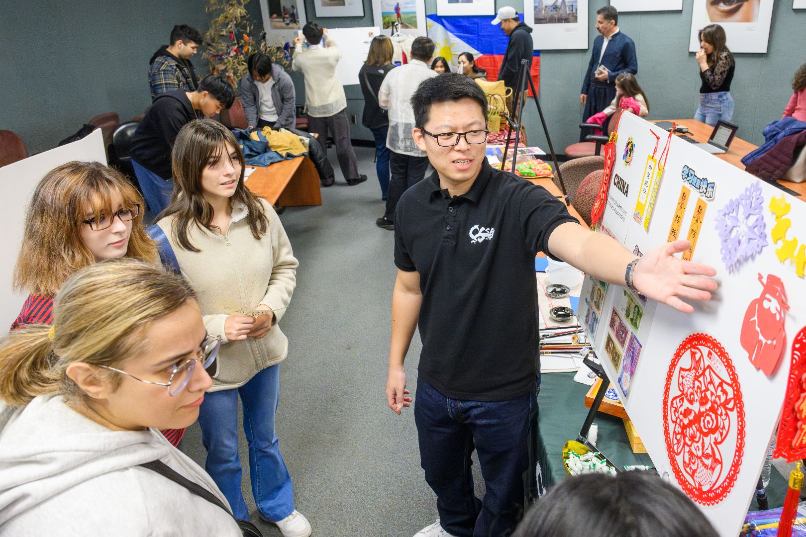 A man explains paper crafts to students at a recent Global Festival