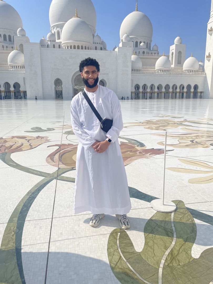 Stoney standing in front of a mosque in Dubai