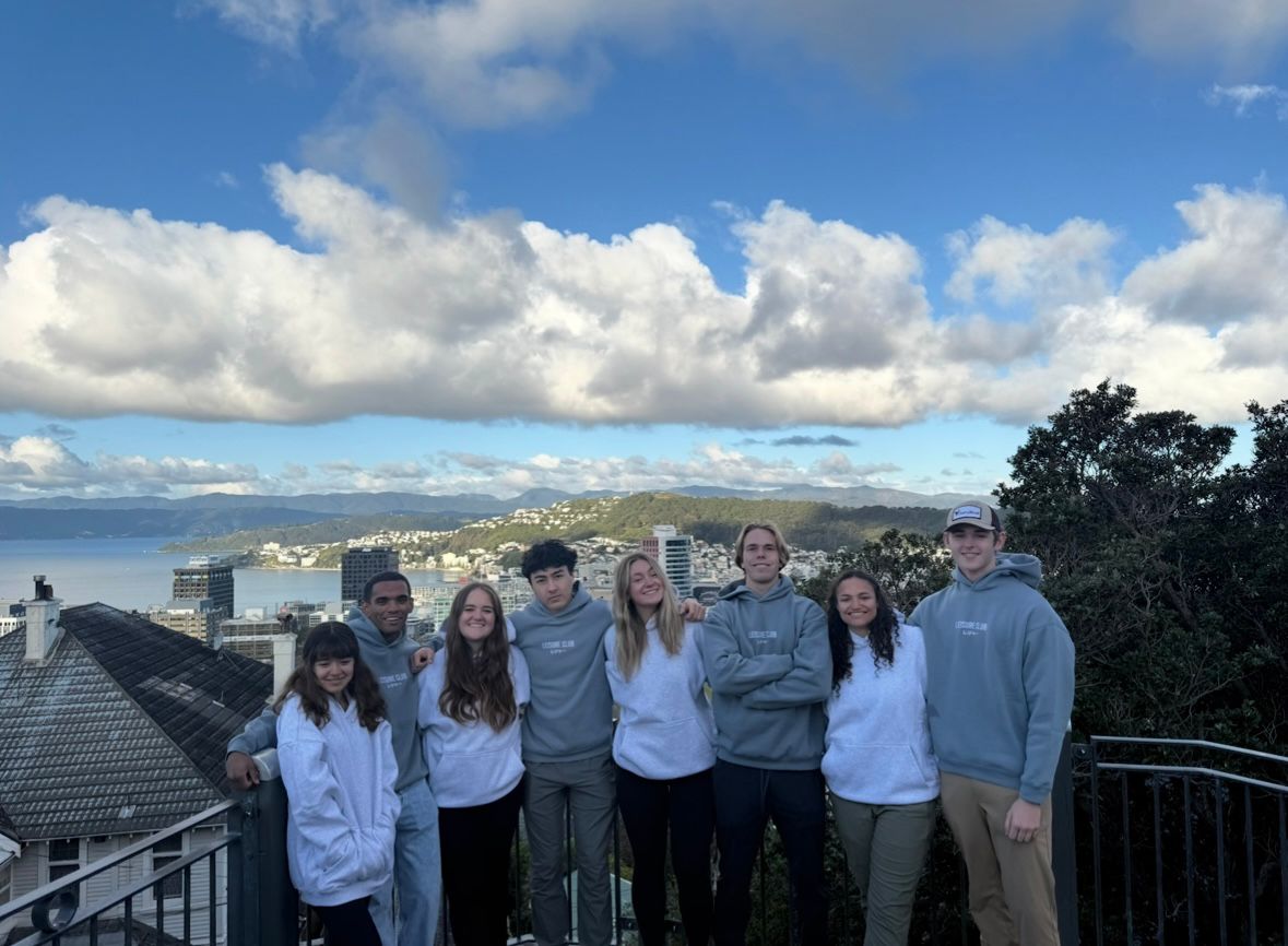 Group of student pose for a group photo on a balcony in New Zealand