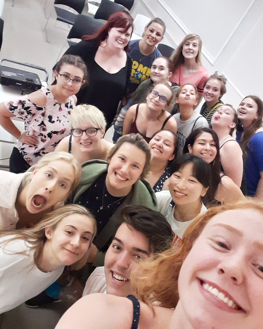 Karen Kangas-Preston poses in a selfie with a group of Theatre in London education abroad students