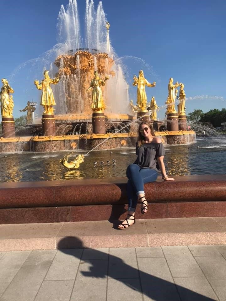 Elysia sitting by fountain in St Petersburg Russia