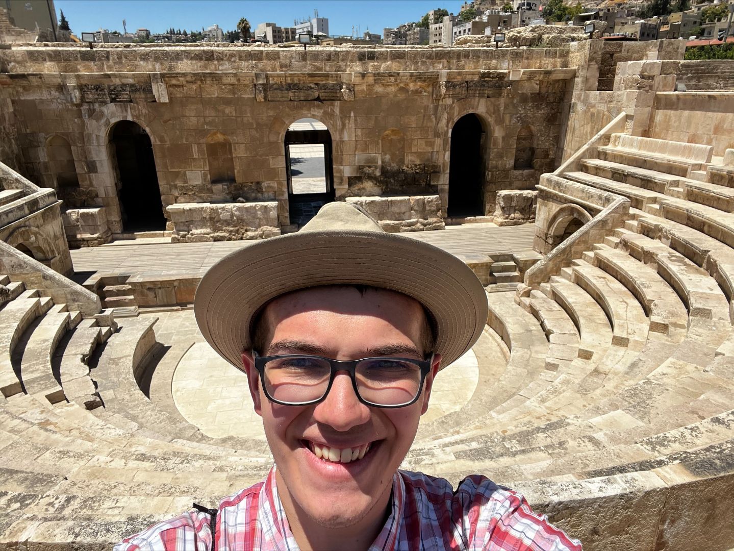Wesley standing in front of Roman theatre in Jordan