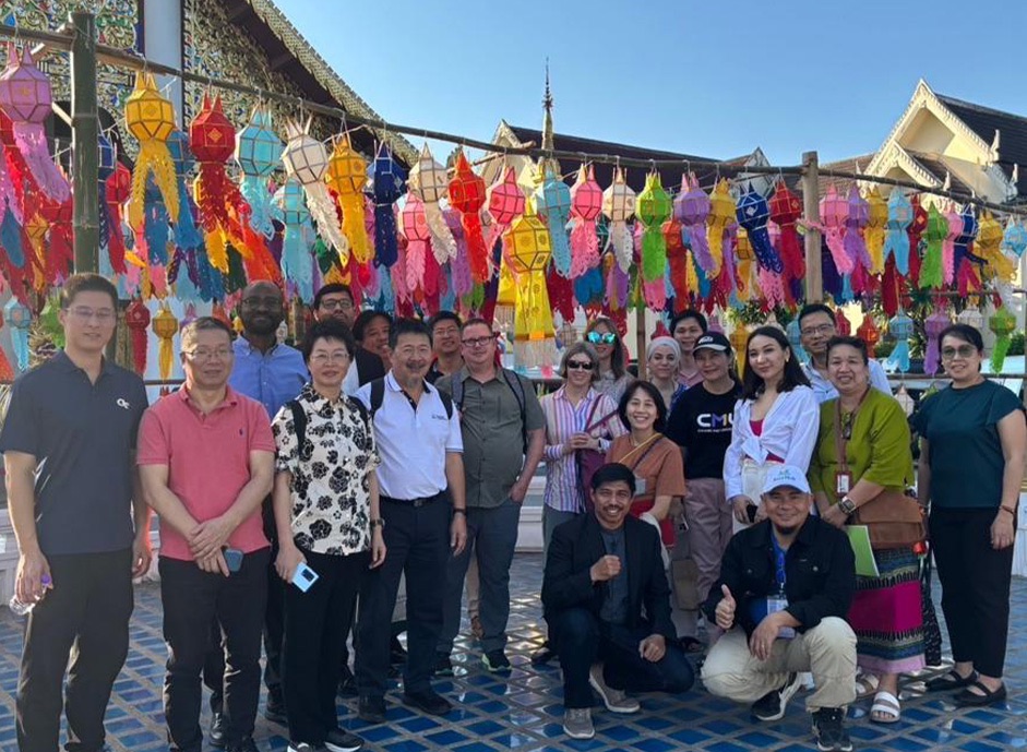 MSU and Chaing Mai University leaders gather outside of a temple in Thailand