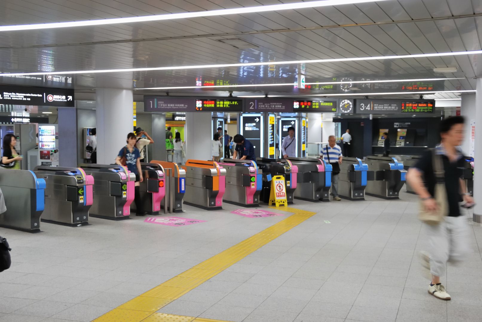 View of ticket gates in a busy train station