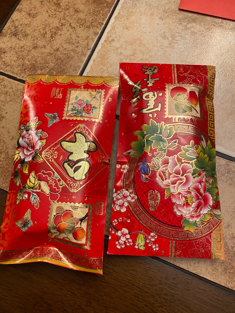 two red envelopes with gold characters 