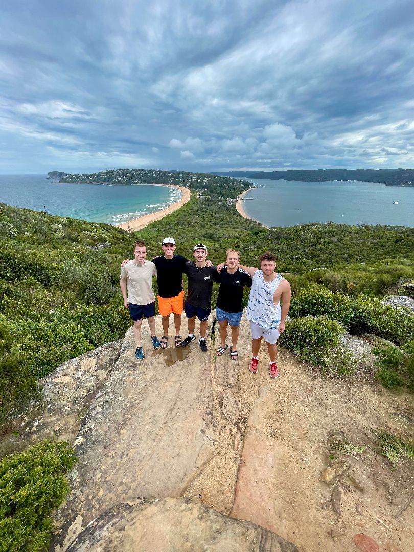 Benjamin and friends at the top of a hill with the ocean in the background