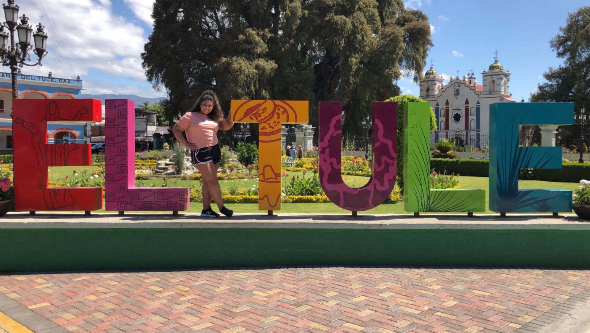 Arianna standing by Oaxaca sign in Mexico