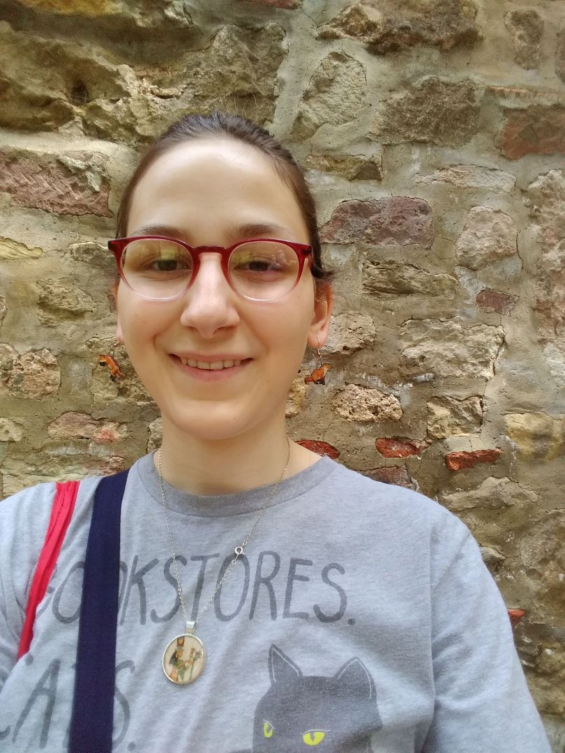 Delaney standing in front of stone wall in Germany