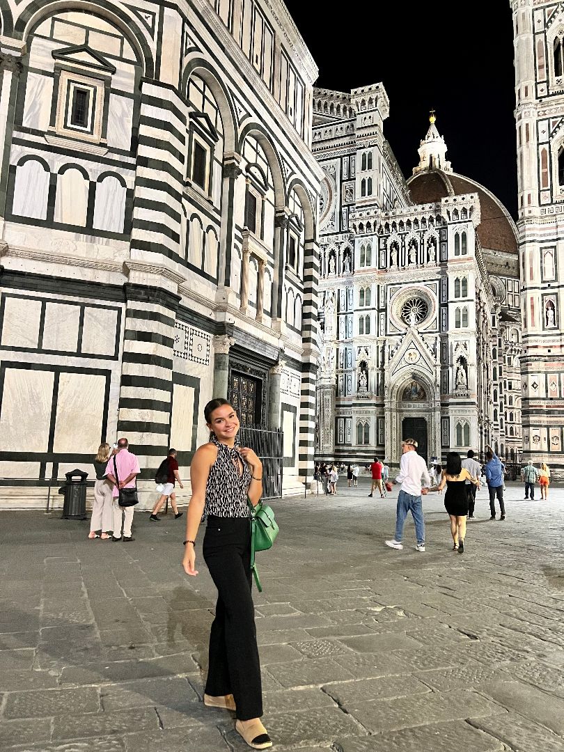 Alana standing in the city of Florence at night
