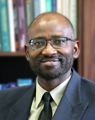 Headshot of a man in a suit smiling at the camera