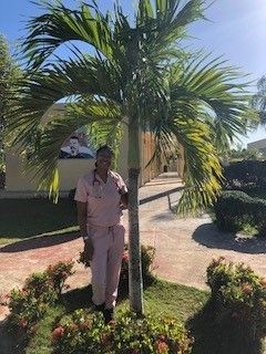 Arianna standing in front of palm tree in the Dominican Republic