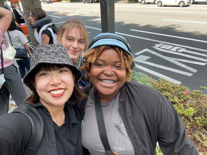 A’Lvinia taking a selfie on a street in Japan with Japanese woman