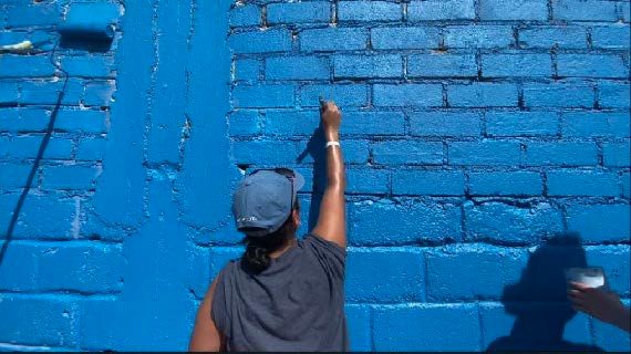 Community project of painting a blue wall