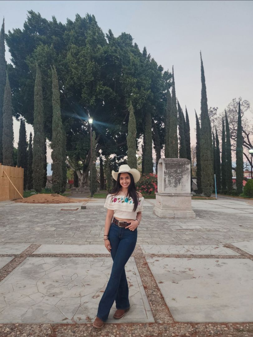 Jocelin wearing a cowboy hat and jeans in Mexico