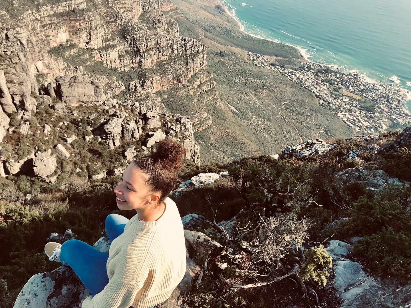 Sarah sitting atop Table Mountain in South Africa