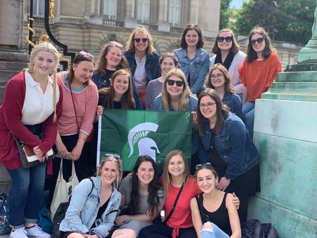 Group of students holding Spartan flag in Europe
