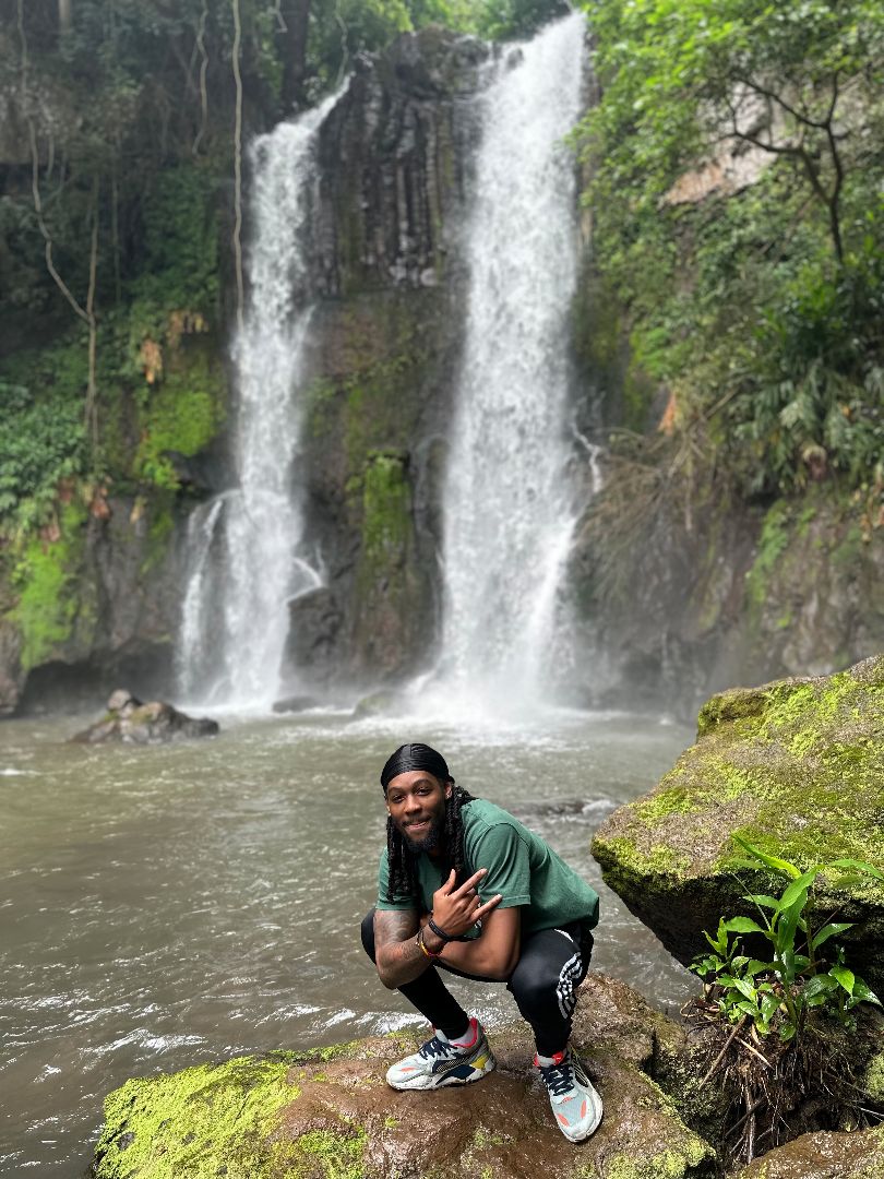 Jalen posing in front of a waterfall