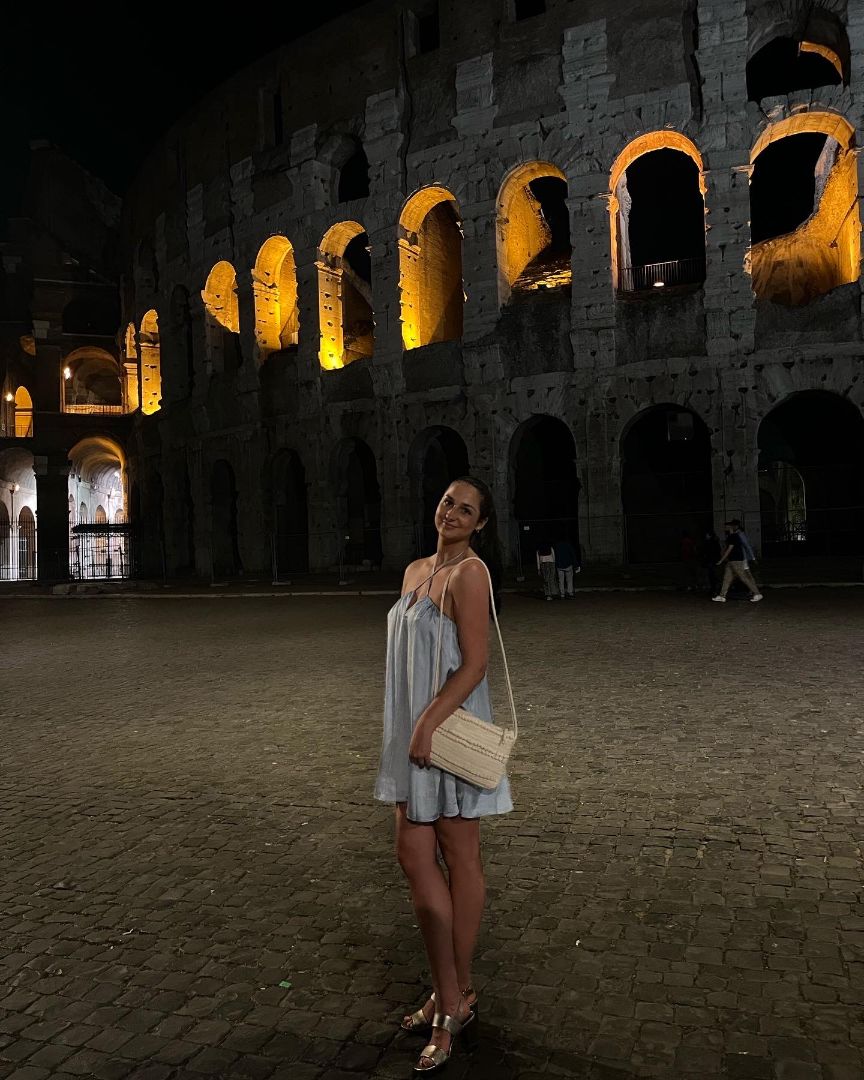 Molly standing in front of Colesium in Rome at night