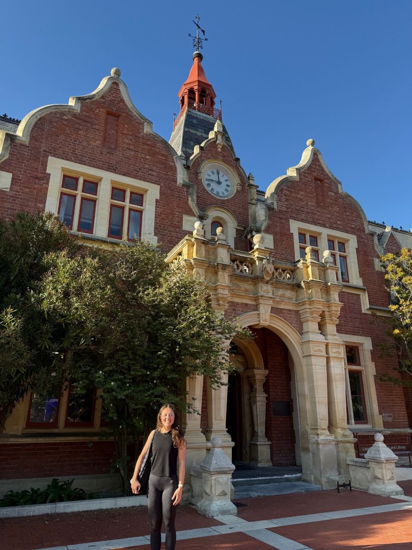 Olivia standing in front of an ornate building at Lincoln University