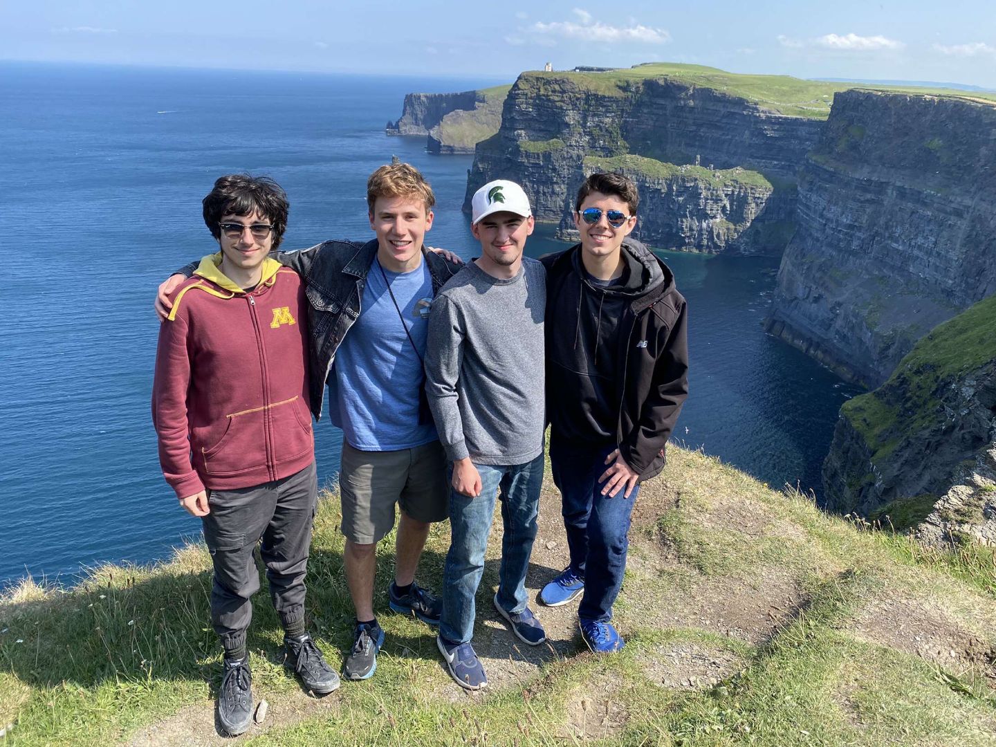 Group of student standing at the top of the Cliffs of Moher in Ireland