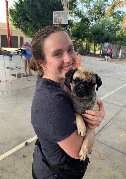 Bethany holding a pug in Mexico