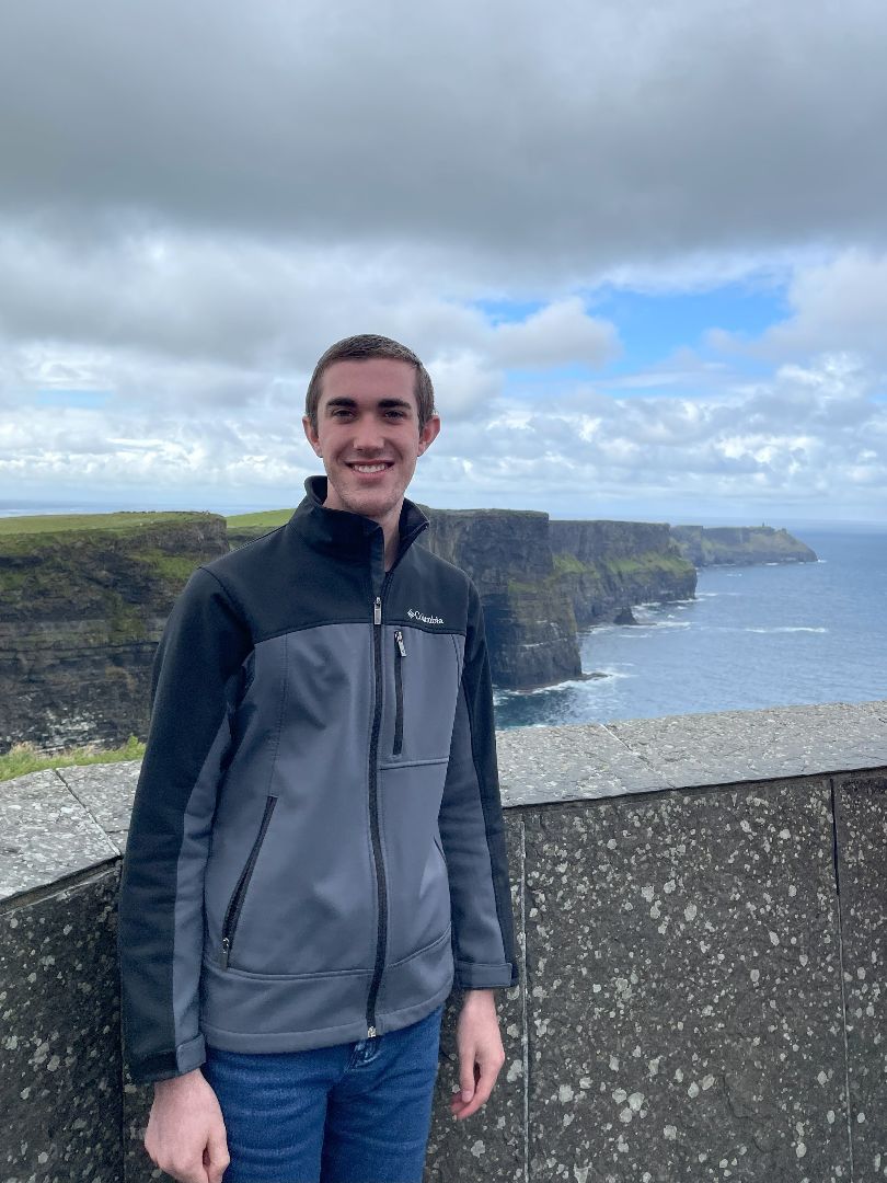 Brandon standing on the Cliffs of Moher in Ireland